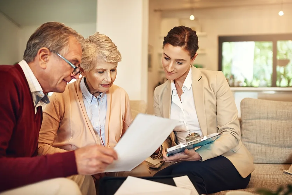 Senior Couple with Financial Advisor doing Paperwork