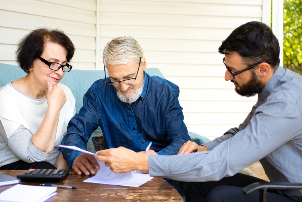 a senior couple discussing plans with a planner